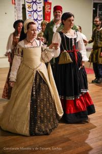 women dressed in Tudor clothes dancing